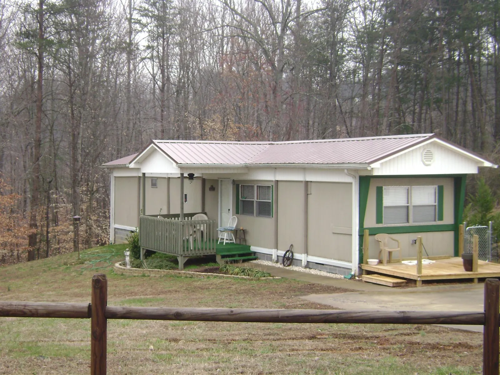 Mauve metal roof on a manufactured home with a new front deck in Locust Grove